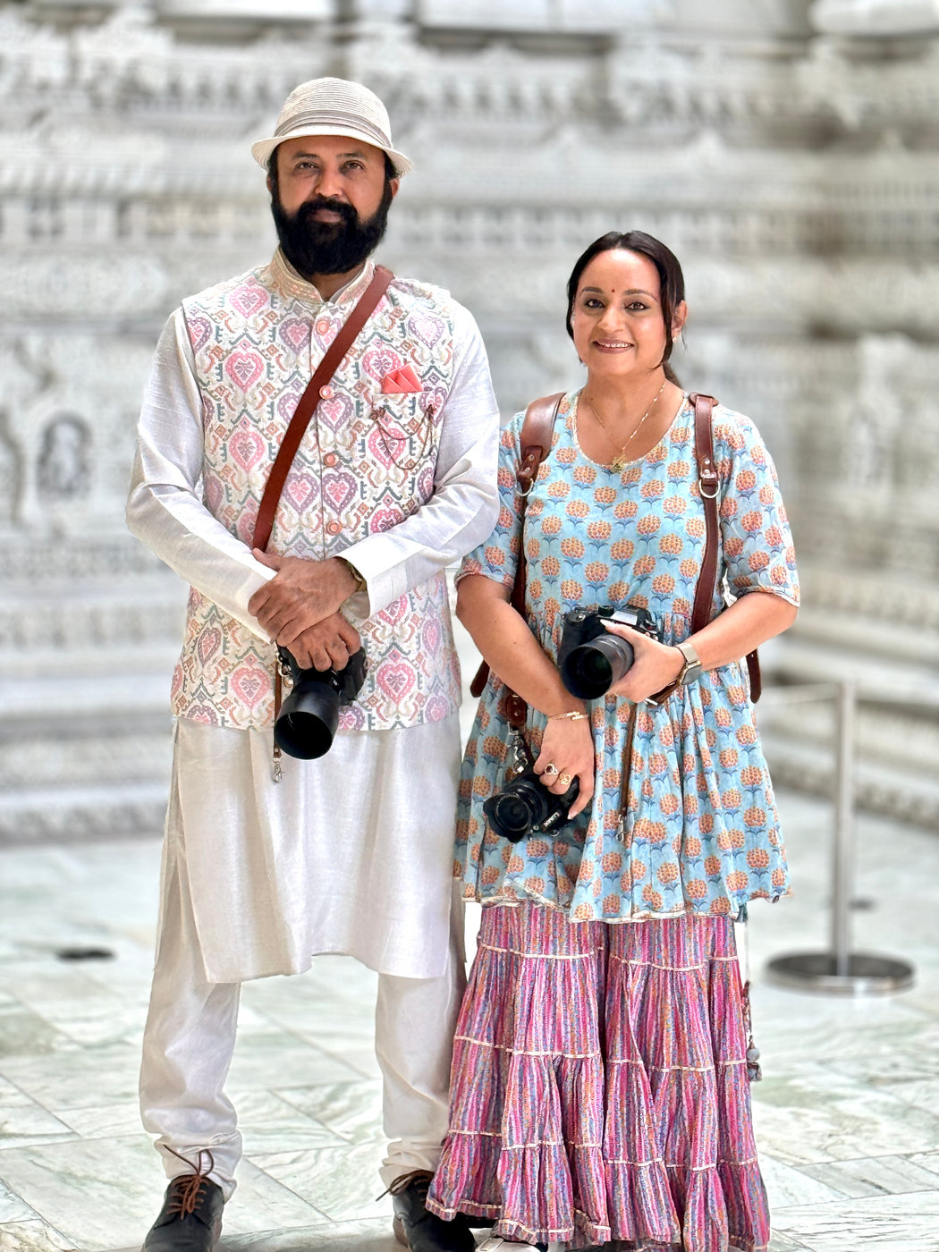 Chirali and Amish Thakkar with their cameras on a wedding shoot